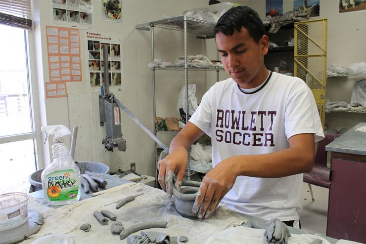 Naaman Forest student building a coil pot