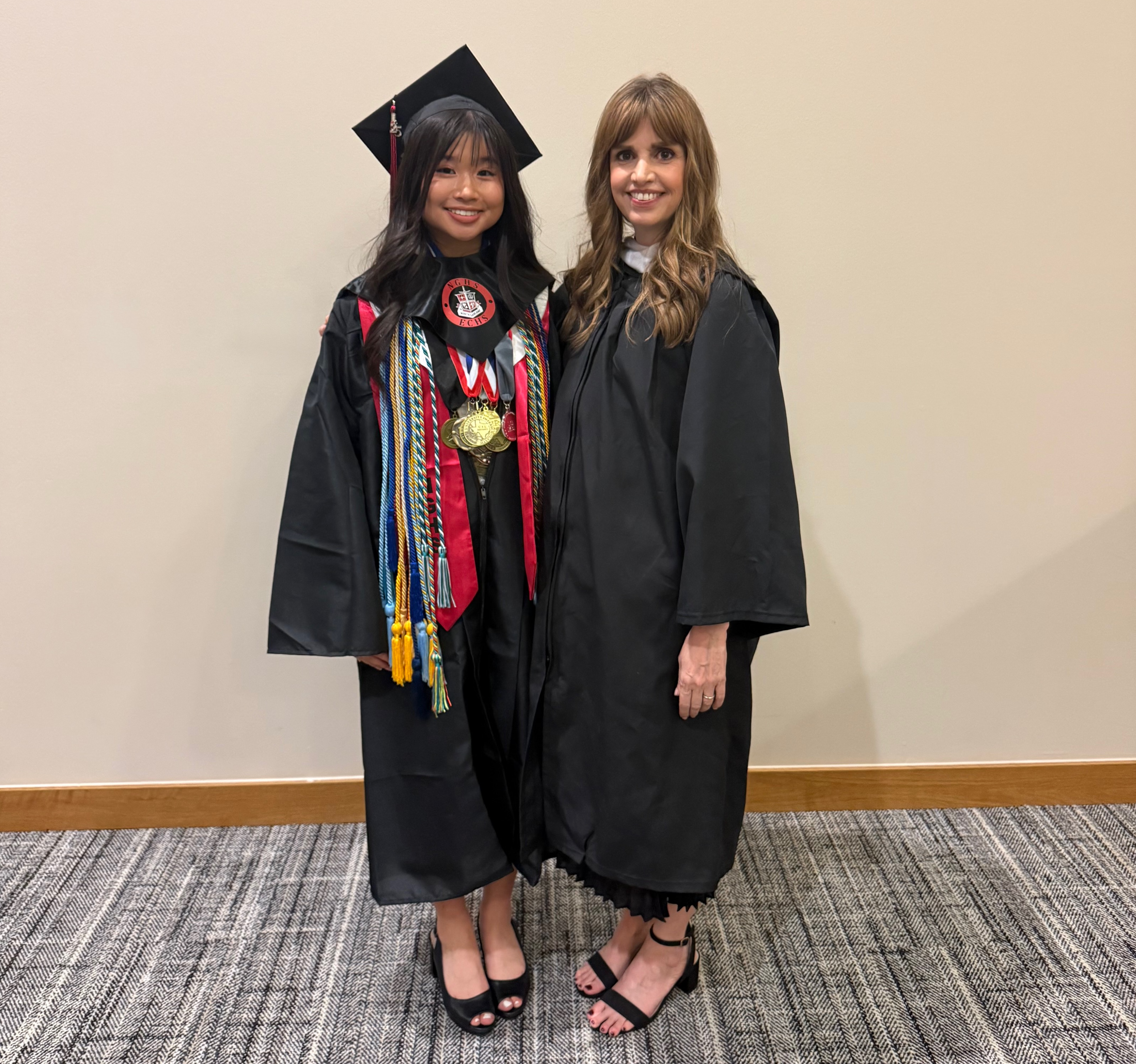 Sarah Nguyen and Anne Rojas pose in graduation regalia