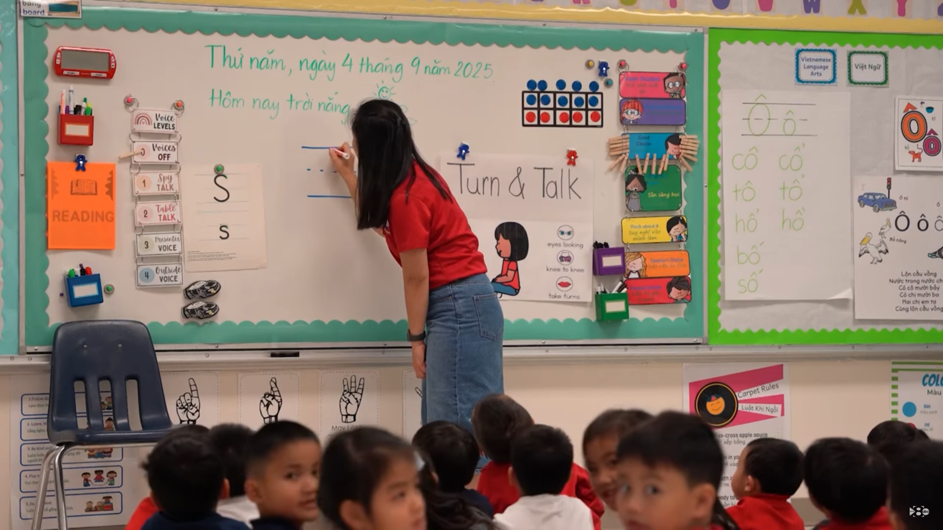 Female teacher writes on the board