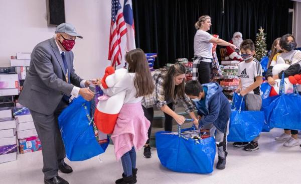 Staff and board trustees hand out donated gifts