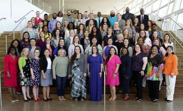 Garland ISD Teachers of the Year from all campuses standing on stairs at the Curtis Culwell Center