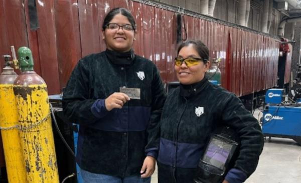 Female Welder in GISD with her Instructor posing with her welding certificate