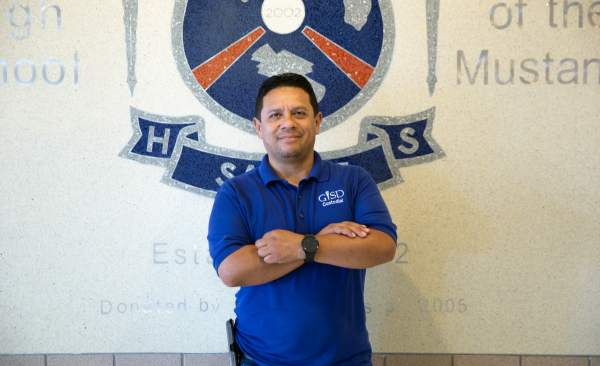 Lio Rodriguez stands with arms crossed