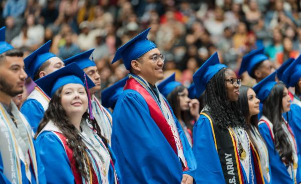 Graduates smile during the ceremony
