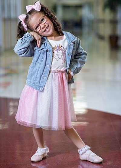 Preschool girl posing with titled head