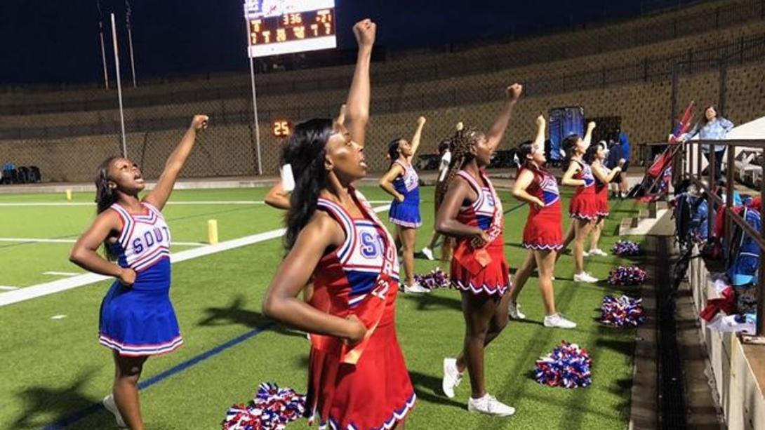 South Garland HS cheerleaders cheering at a football game