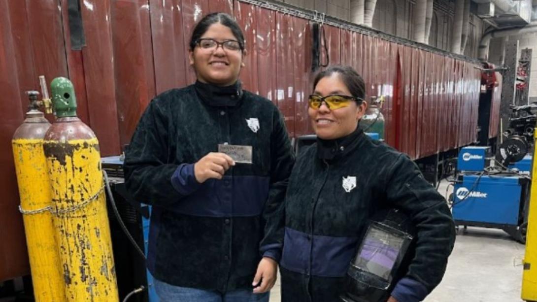 Female Welder in GISD with her Instructor posing with her welding certificate