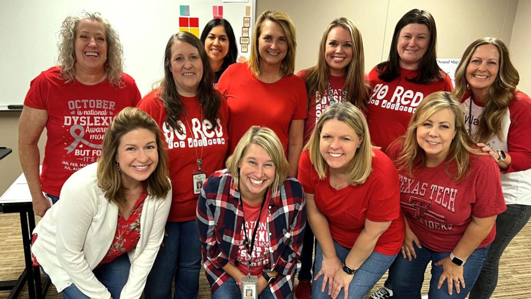  Several Garland ISD Dyslexia Therapists smile in a classroom together after a training session.
