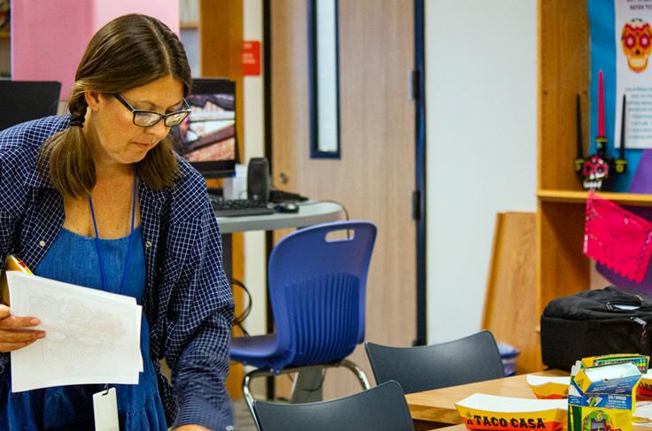 SGHS Librarian Lisa Latham works to organize a Hispanic Heritage activity station.