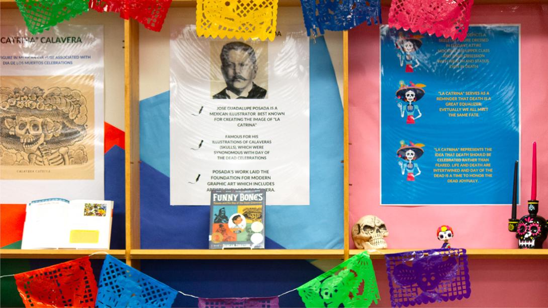 A display shows the colorful history of Dia De Los Muertos, covering the history of La Catrina, Jose Guadalupe Posada, and the holiday.