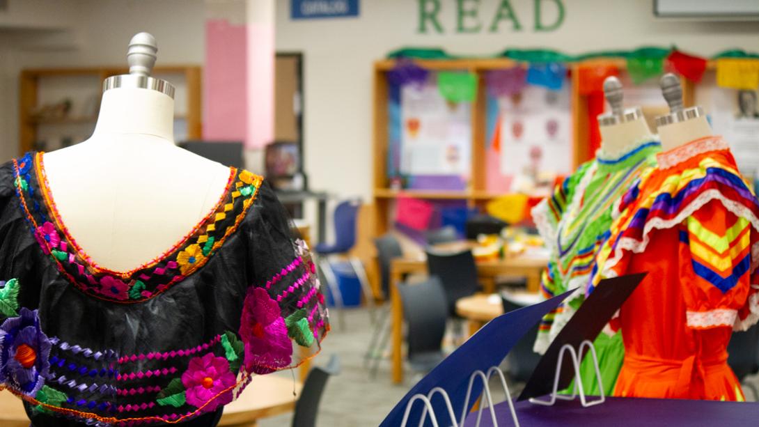 Several colorful Folkloric dresses sit as part of the Hispanic Heritage Museum at South Garland High School's library.