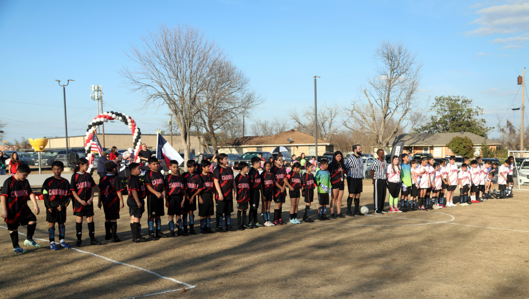 Caldwell soccer clubs stands in a line in their uniforms