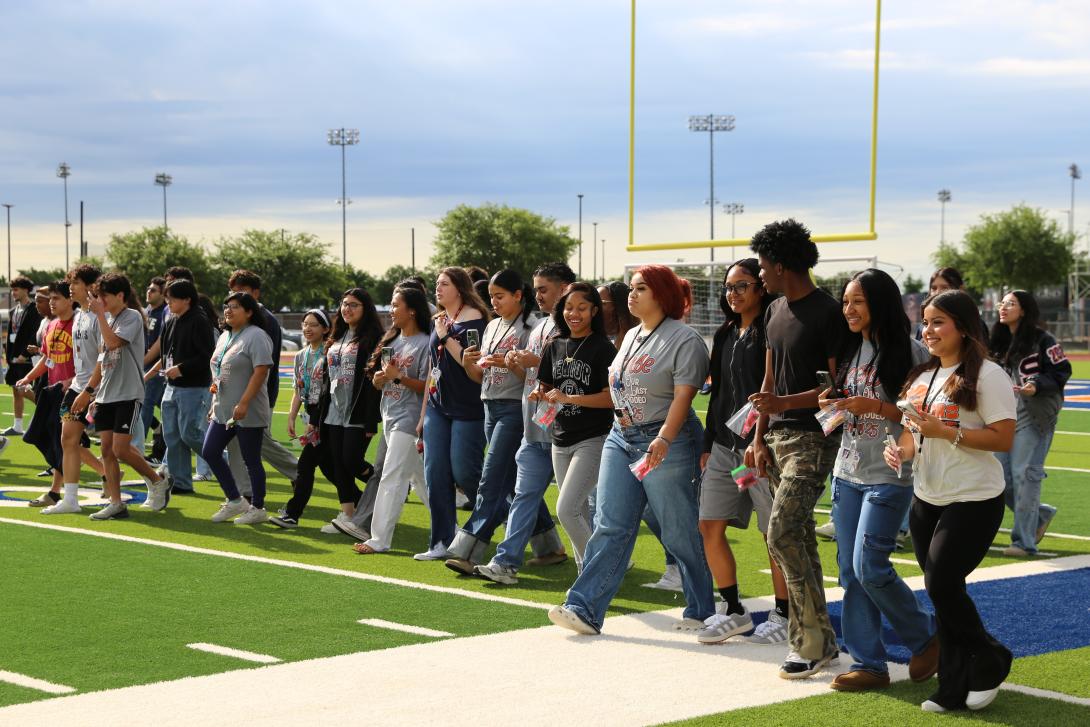 Seniors walk next to each other on the field