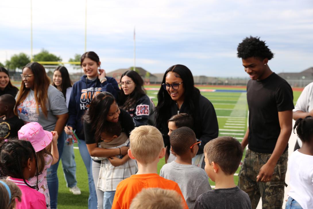 Students hug and share smiles