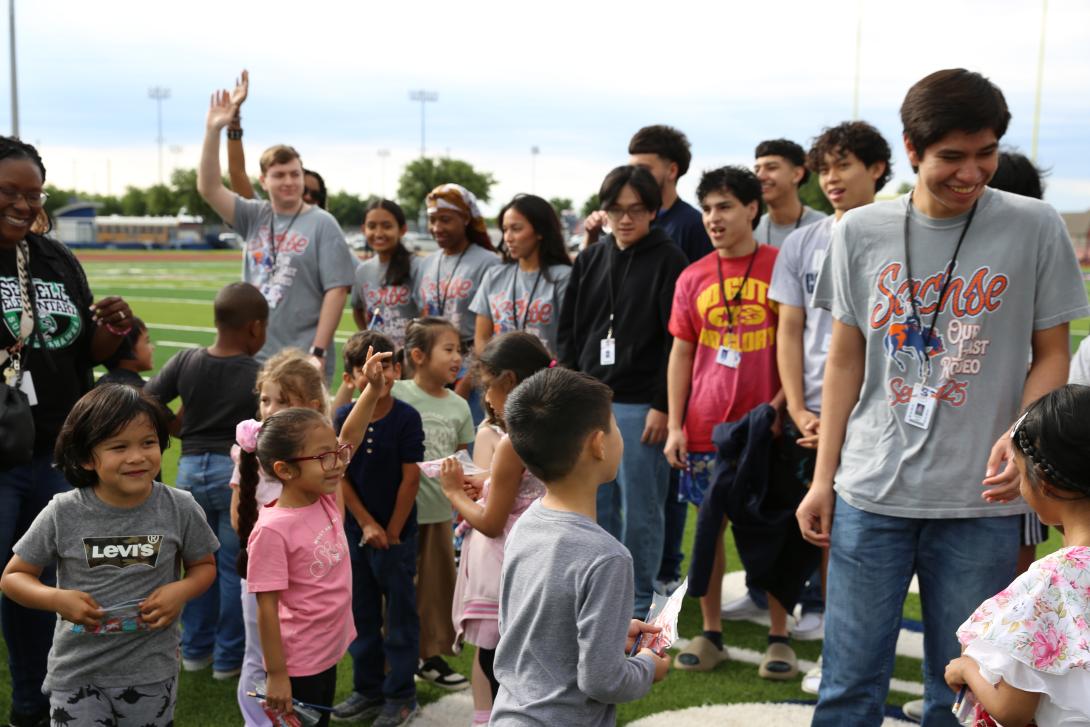 Seniors and kindergarteners smile and give high fives