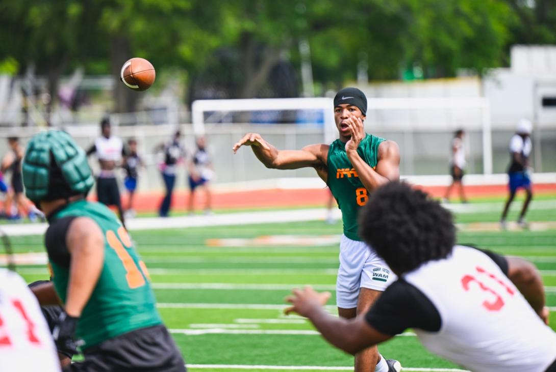 Football plays throws the football to another player 