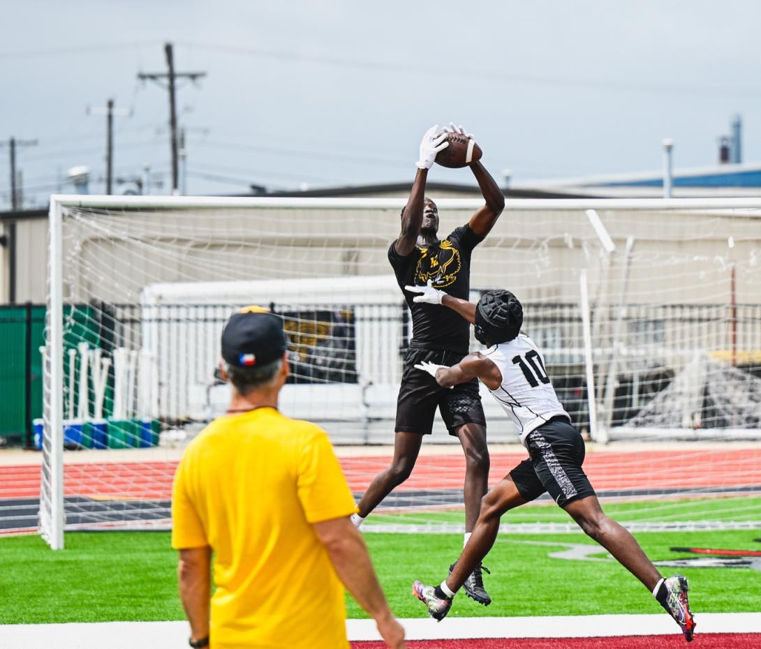 Football player catches the ball mid-air