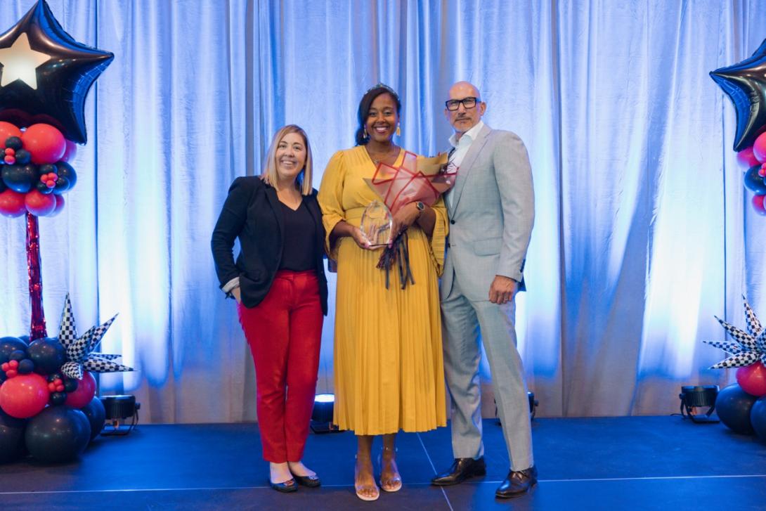 Ashley Ross stands with superintendent Dr. Lopez and an official from Region 10