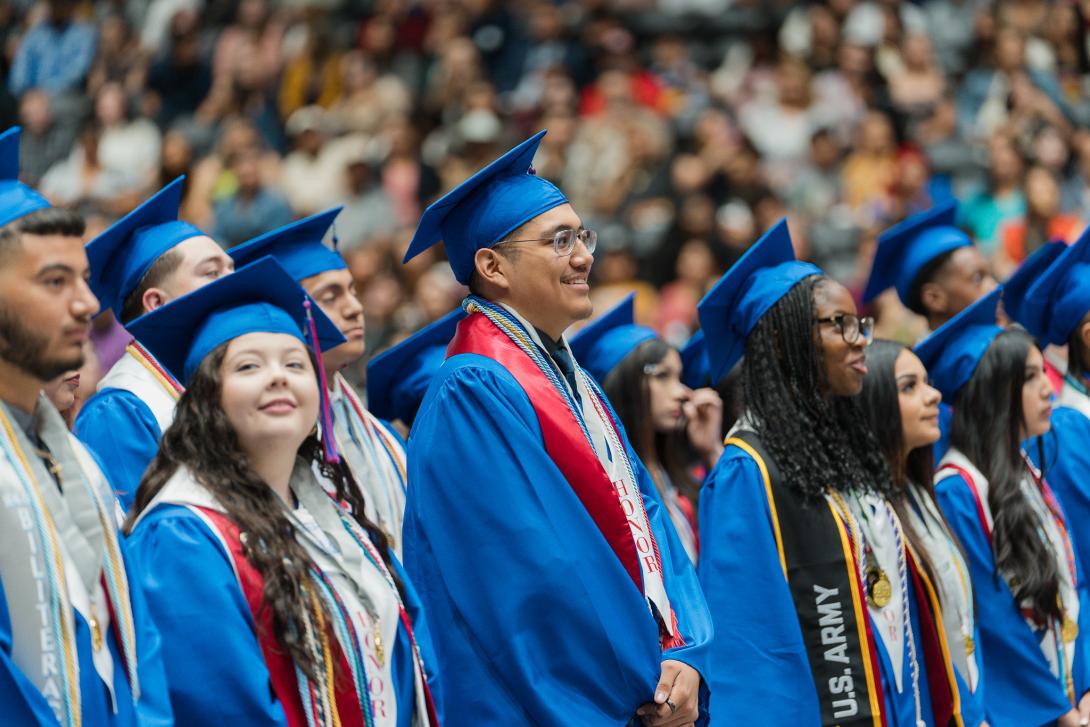 Graduates smile during the ceremony