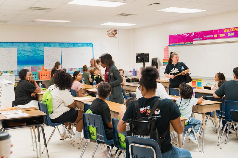 A woman speaks to a classroom of parents