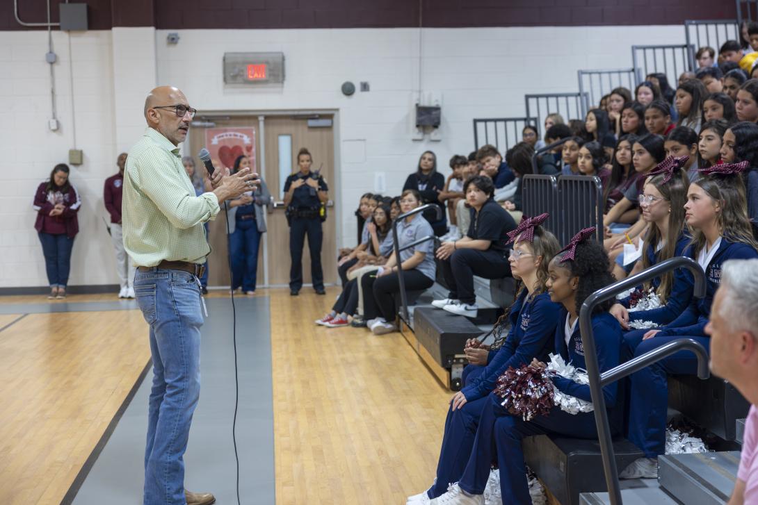 Dr. Lopez addresses a large group of students