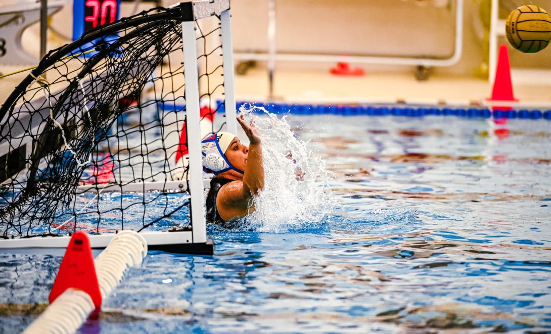 female water polo player defends the goal