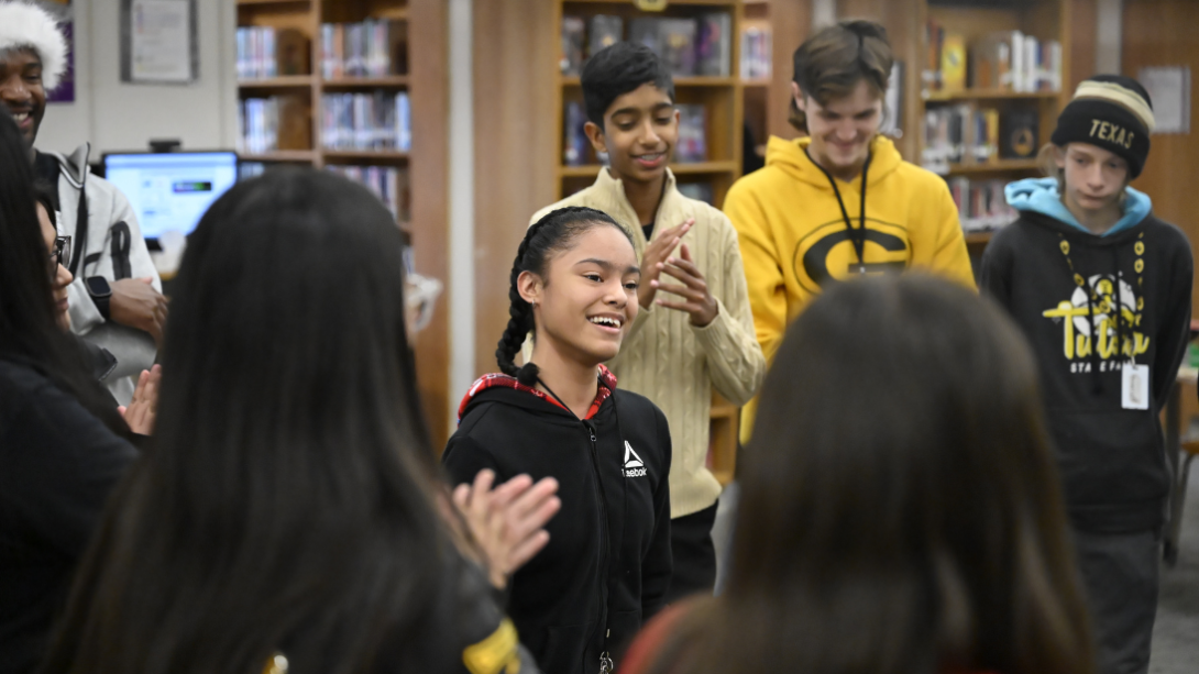 A student smiles as she plays a party game