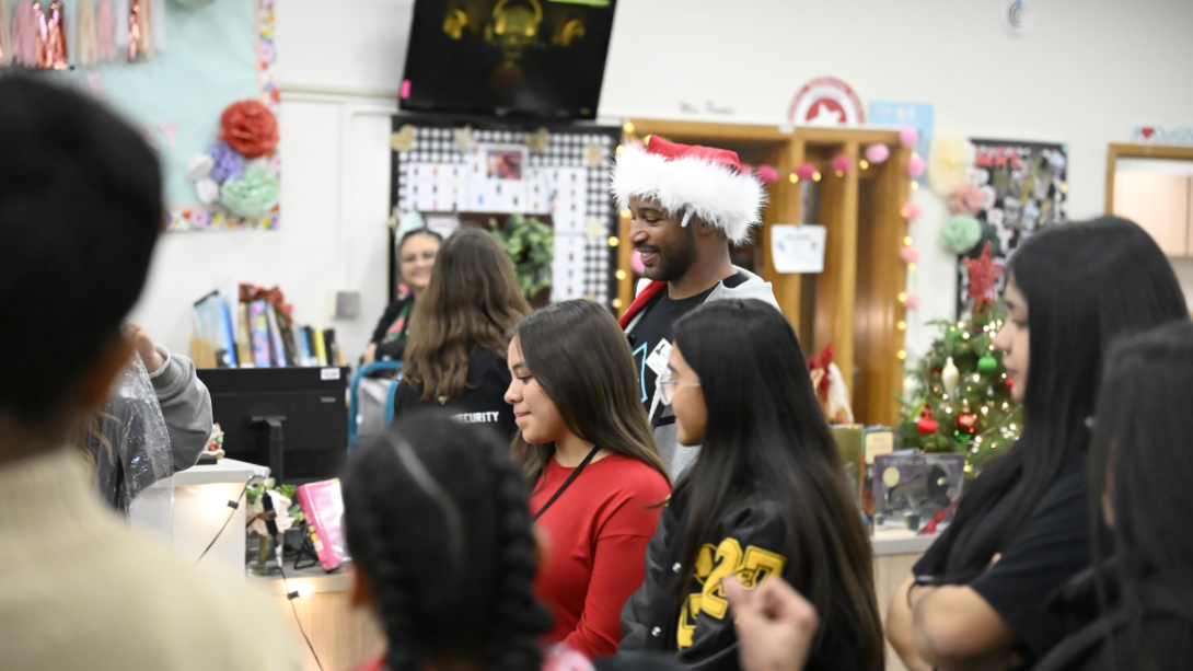 Students smile as they play a holiday party game