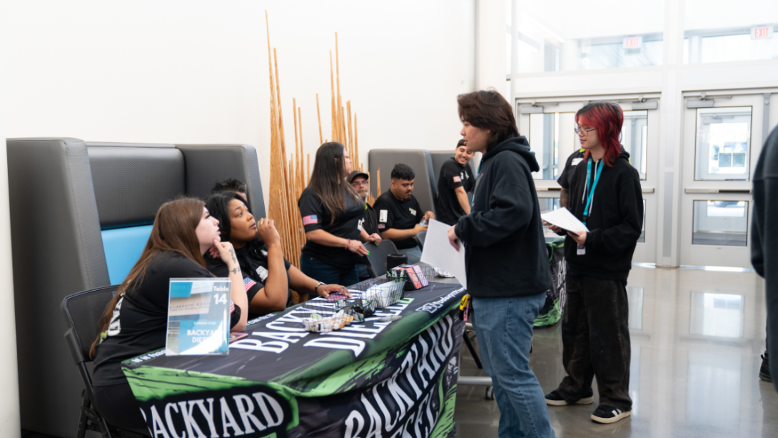 Students speak with prospective employers at a job fair