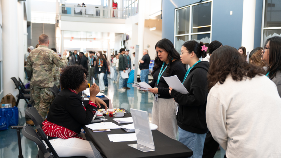 Students speak with prospective employers at a job fair