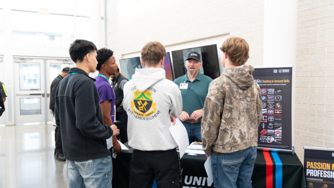 Students speak with prospective employers at a job fair
