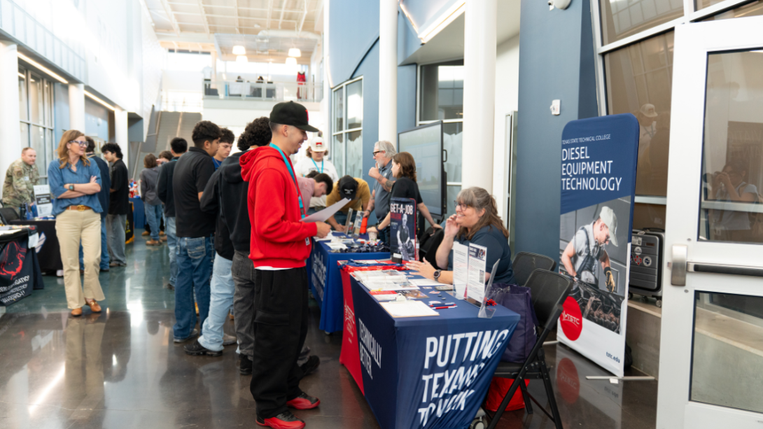 Students speak with prospective employers at a job fair