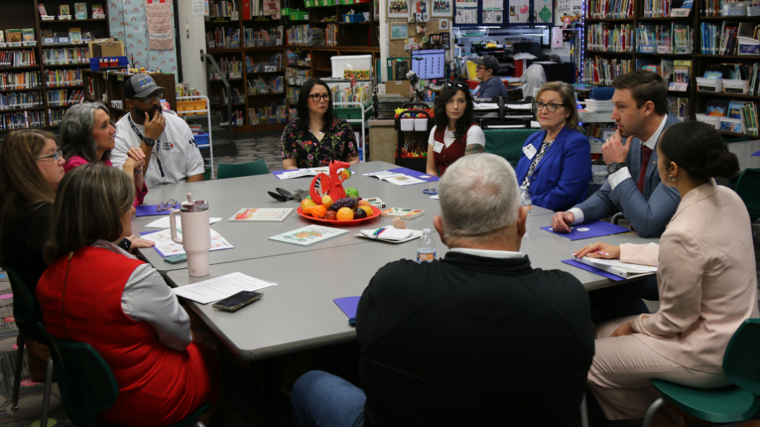 a diverse group of adults engage in a roundtable discussion