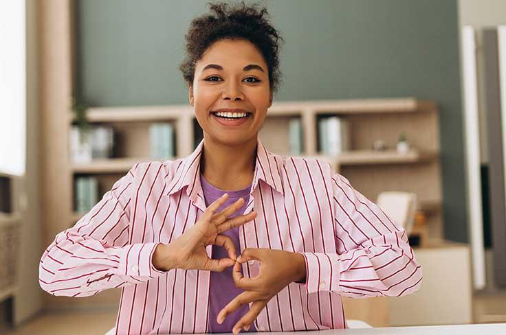 Smiling woman using sign language