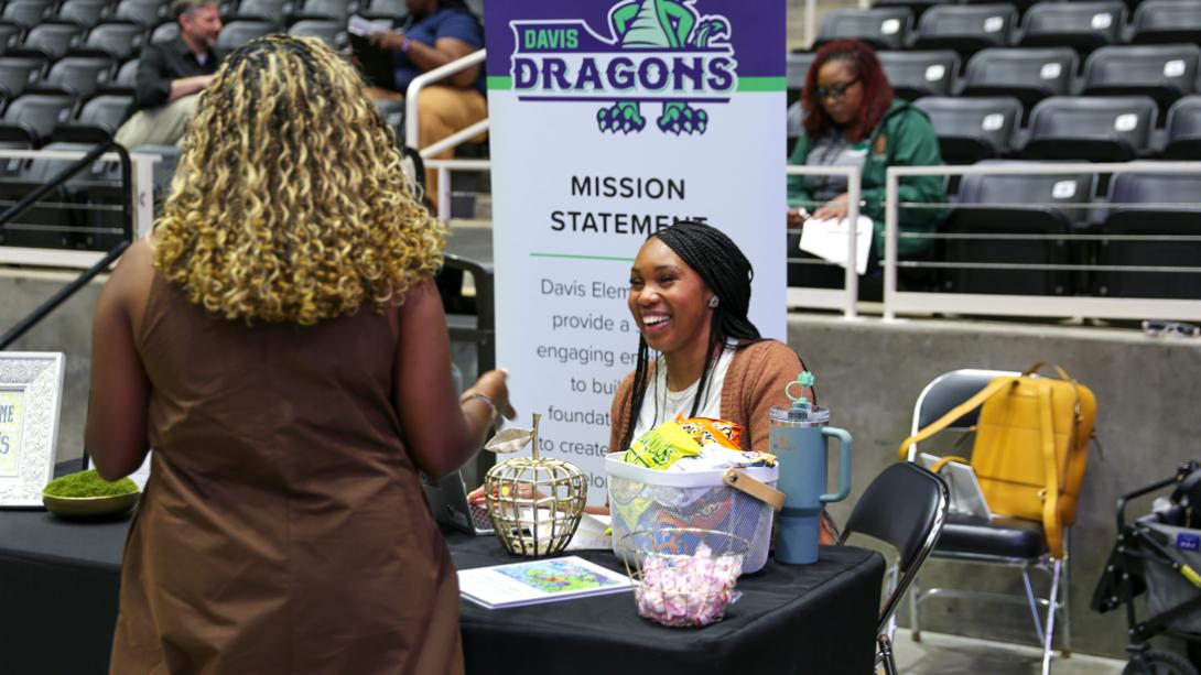 A Davis Elementary staff member shares a laugh while interviewing a potential staff member.