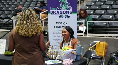 A Davis Elementary staff member shares a laugh while interviewing a potential staff member.
